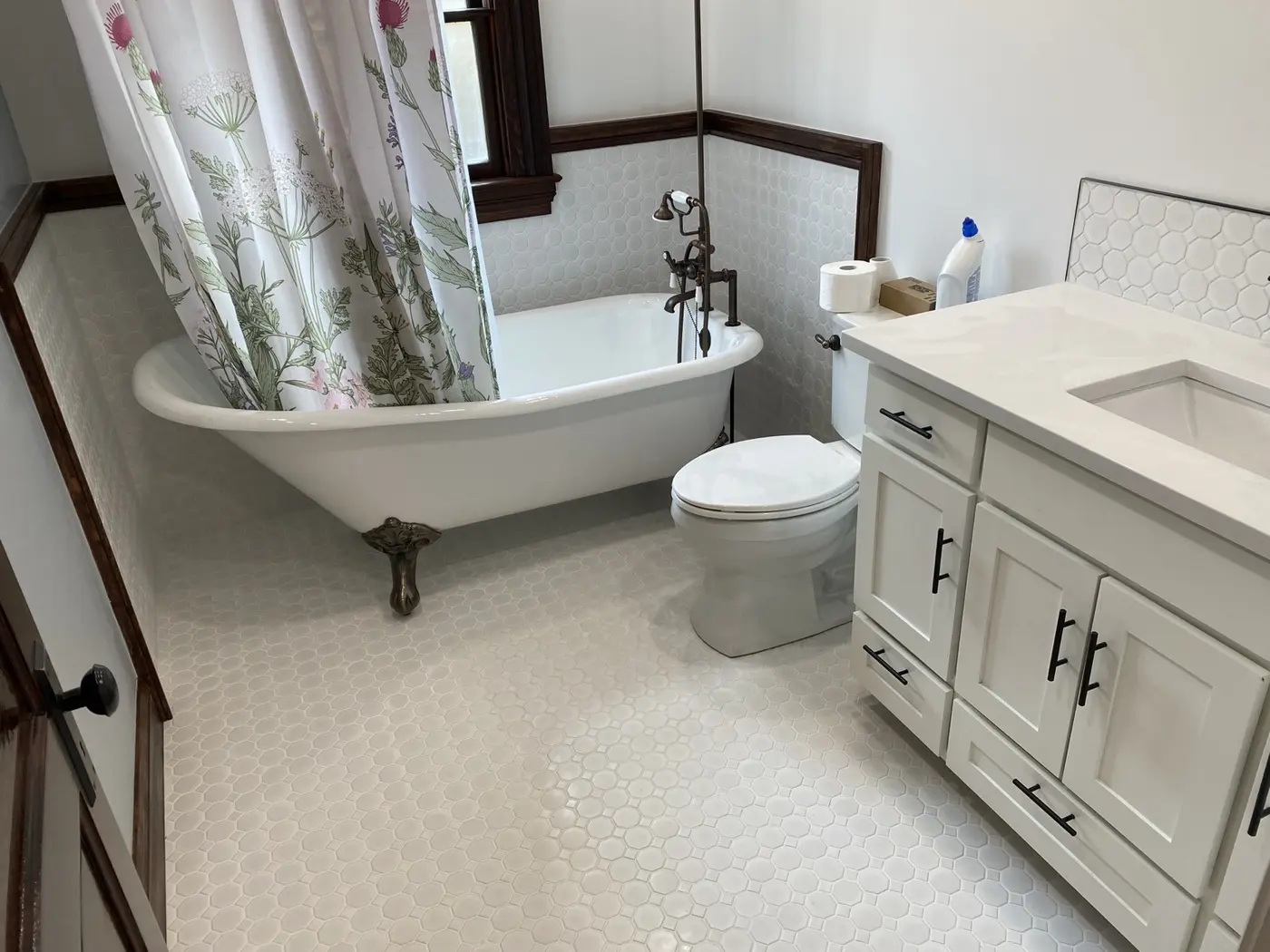 Clawfoot tub bathroom with hexagon tile